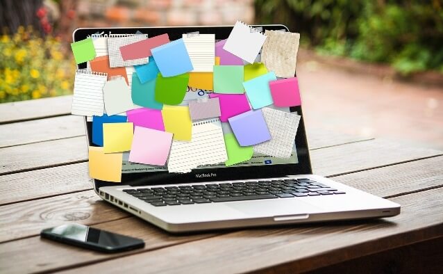 a laptop covered in sticky notes